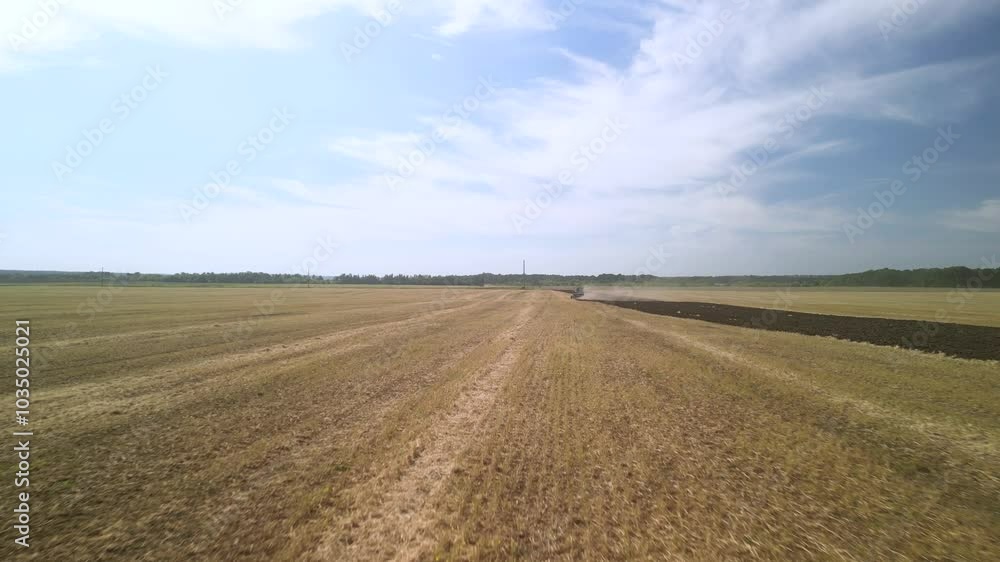 Aerial View of Tractor Plowing Farmland. Tractor and Plow Turning the Soil Aerial View of Tractor Plowing Farmland. Tractor and Plow Turning the Soil