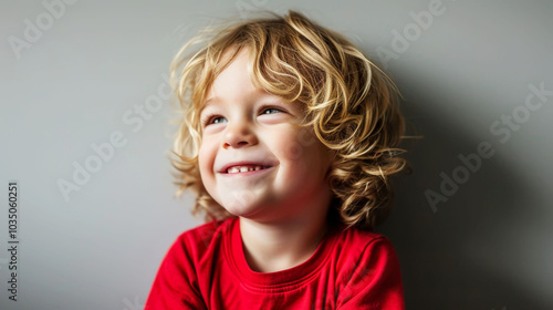 Blonde German preschooler in red with a joyful expression