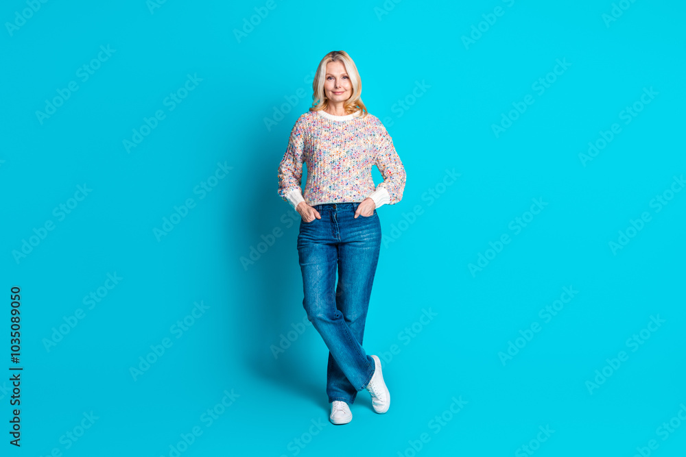 Full size photo of pretty aged lady posing wear pullover isolated on turquoise color background Full size photo of pretty aged lady posing wear pullover isolated on turquoise color background