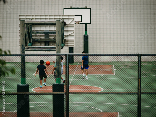 Children playing basketball in a playground from Hong Kong, China