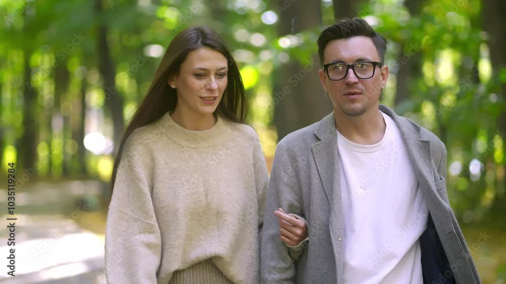 A joyful couple savoring a delightful walk together in a serene green park, conveying deep love and connection