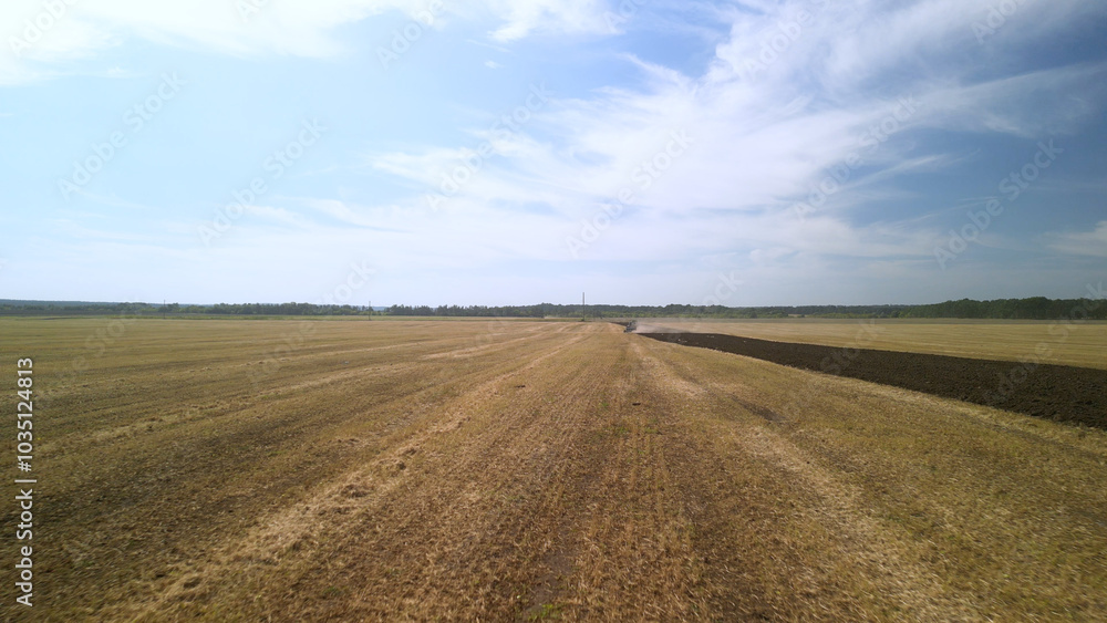 Aerial View of Tractor Plowing Farmland. Tractor and Plow Turning the Earth Aerial View of Tractor Plowing Farmland. Tractor and Plow Turning the Earth