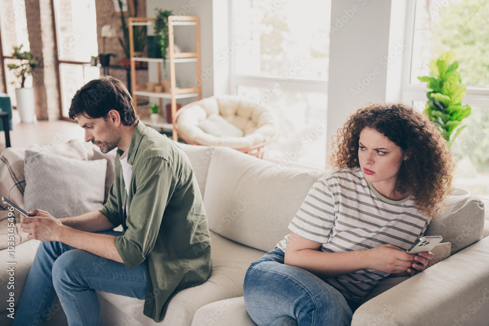Portrait of two young partners hide smart phone chatting living room flat indoors Portrait of two young partners hide smart phone chatting living room flat indoors