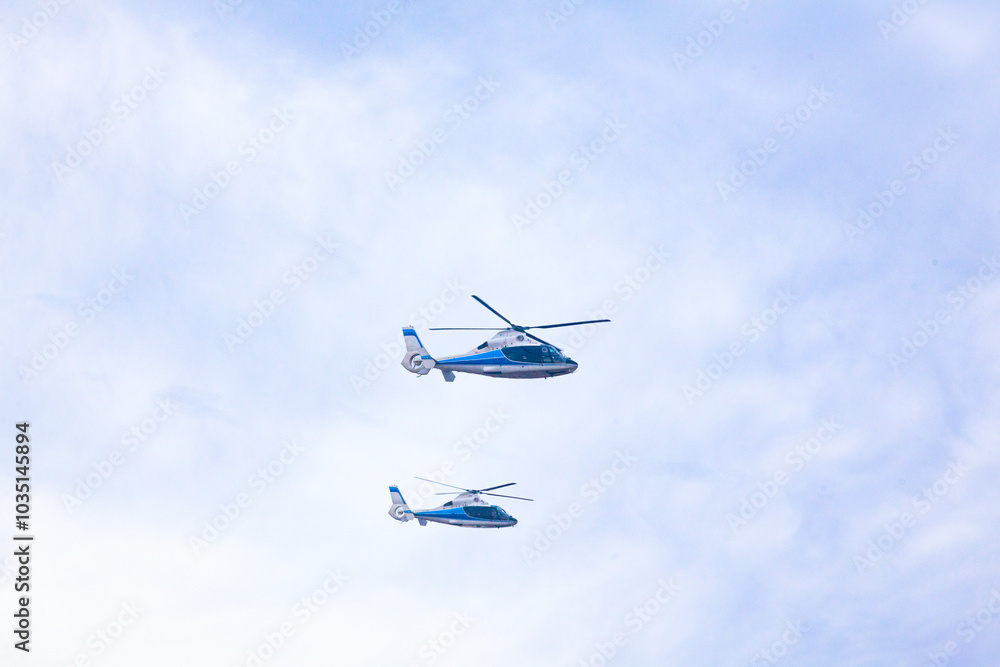 Two transport helicopters are flying in the sky. Two transport helicopters are flying in the sky.