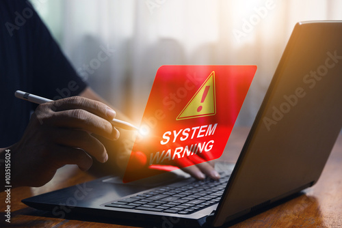 Man using computer with warning triangle sign for error notification and maintenance concept Hacker attacks and data hacking Cyber ​​Crime Ransomware Phishing Spyware Cyber ​​Security