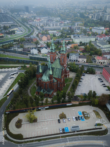 Aerial view of the Church of the Holy Cross surrounded by urban cityscape and historic buildings, Kielce, Poland. photo