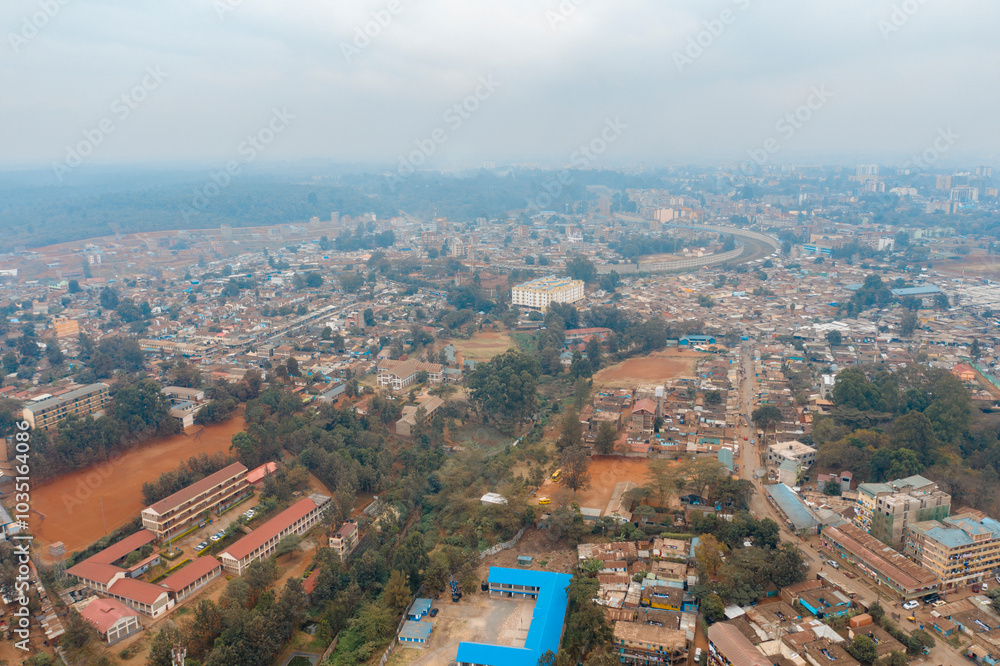 Aerial view of dense residential buildings and roads in Kibera slum, Nairobi, Kenya. Aerial view of dense residential buildings and roads in Kibera slum, Nairobi, Kenya.