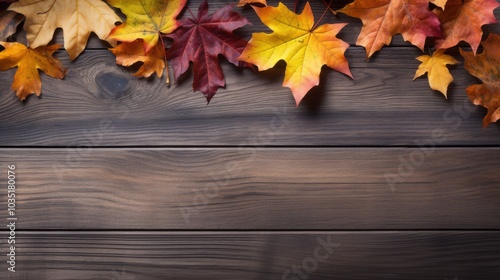 Stunning autumn leaves in vibrant reds and yellows grace a weathered wooden surface, symbolizing change and nature's artistry. photo