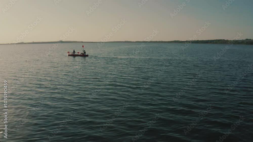 Two people in a kayak on the water of the lake on a warm sunny day. Recreation on the water, active recreation, sports Two people in a kayak on the water of the lake on a warm sunny day. Recreation on the water, active recreation, sports