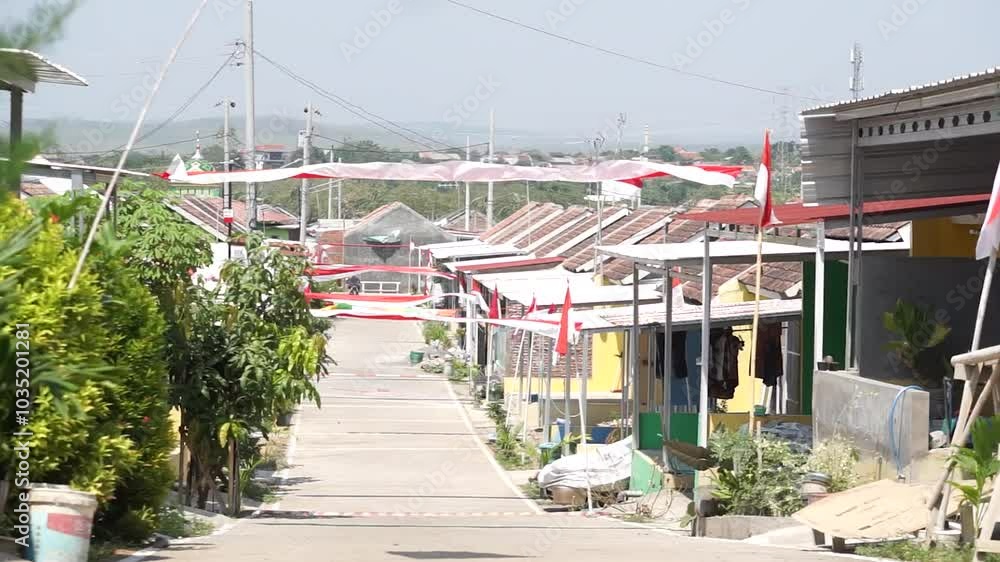 The Indonesian flag named Sang Saka Merah Putih flutters on a pole in front of the house commemorating Indonesia's Independence Day The Indonesian flag named Sang Saka Merah Putih flutters on a pole in front of the house commemorating Indonesia's Independence Day