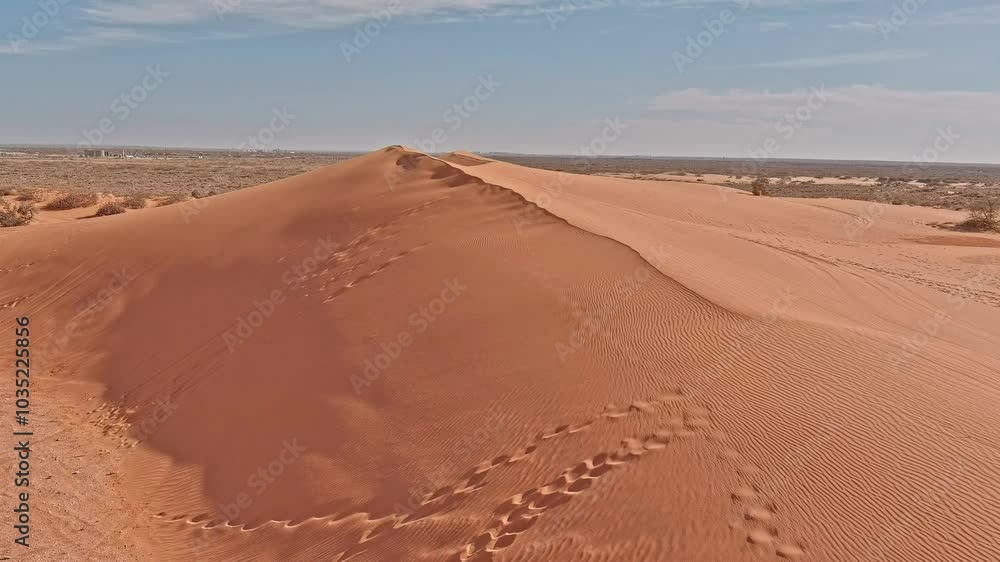 Aerial view of vast sandy dunes with footprints under a sunny sky, Carlsbad, United States. Aerial view of vast sandy dunes with footprints under a sunny sky, Carlsbad, United States.