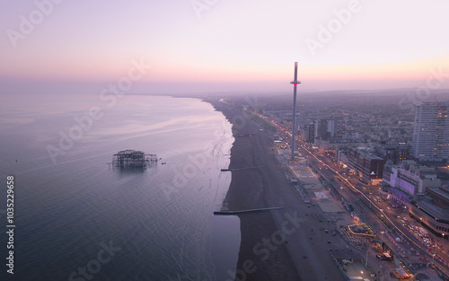 Aerial view of beautiful Brighton cityscape at sunset with bustling pier and coastline, Brighton, United Kingdom.