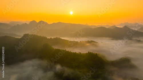 Orange sky and sea of clouds before sunrise. A peaceful, refreshing feeling. View of the hills surrounding Ba Quang, Ha Lang district, Cao Bang province, Vietnam