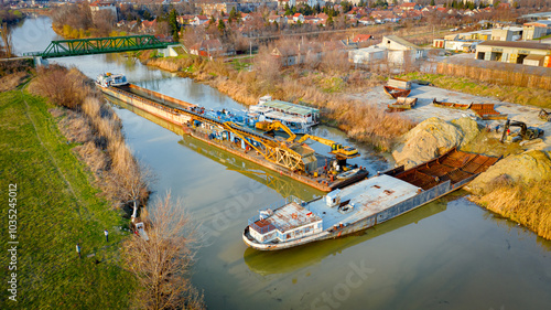 Aerial view on workers as they manually cutting old ship with blowtorch, mixing oxygen and acetylene gas, propane
