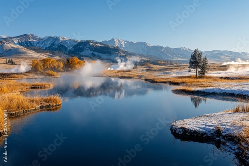 Golden autumn foliage and steam rising from geysers at Yellowstone National Park during a clear morning