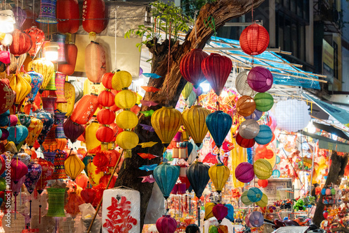 Photography People in front of traditional colorful lanterns hanging on a stand in Hang Ma s