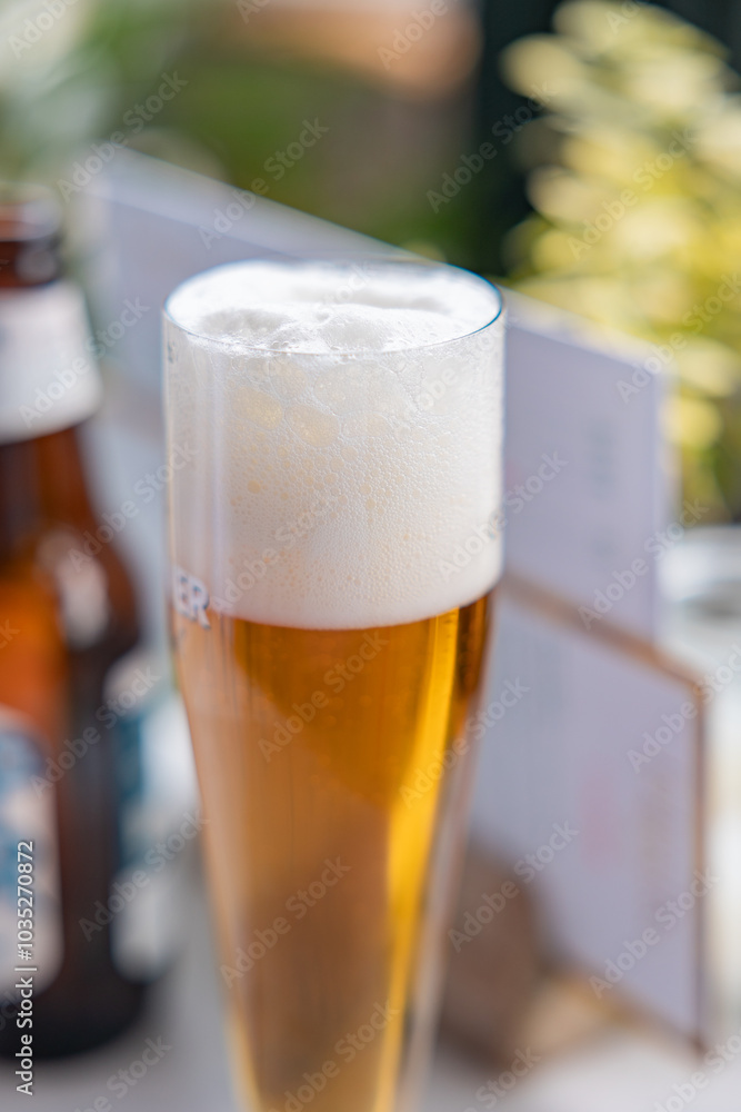 Glass of beer with a head of foam. Table in the restaurant. The Hague, Netherlands. Glass of beer with a head of foam. Table in the restaurant. The Hague, Netherlands.