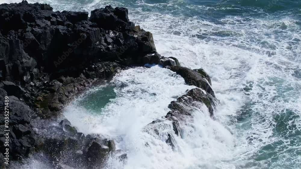 Aerial view of a natural pool surrounded by rugged rocks and crashing waves, Brimketill, Iceland. Aerial view of a natural pool surrounded by rugged rocks and crashing waves, Brimketill, Iceland.