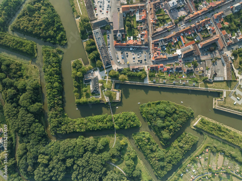 Aerial view of the fort city with historical fortifications and a river surrounded by greenery, Gravelines, France. photo