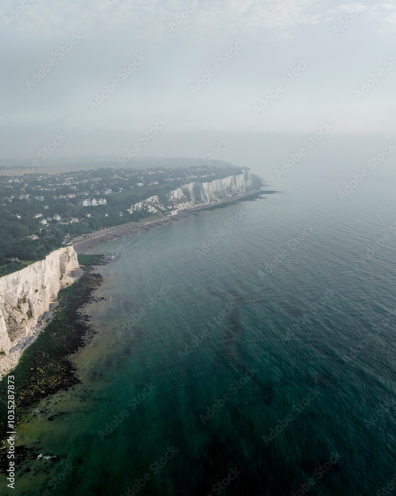 Aerial view of the majestic white cliffs of Dover along the serene English Channel, St Margaret's at Cliffe, United Kingdom. Aerial view of the majestic white cliffs of Dover along the serene English Channel, St Margaret's at Cliffe, United Kingdom.