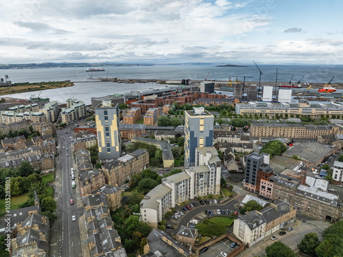 Aerial view of modern buildings and harbor along the Water of Leith with cranes and streets, North Leith, Edinburgh, United Kingdom. photo