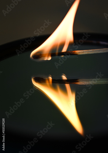 burning match reflecting in the mirror