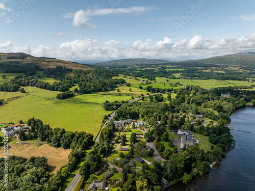 Aerial view of tranquil Loch Lomond surrounded by lush hills and picturesque village, Trossachs National Park, United Kingdom. photo