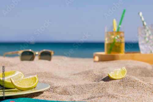 Canvas Print Beach, sea and sky view, ice bucket and straws on the sand, sunglasses and cut lemons