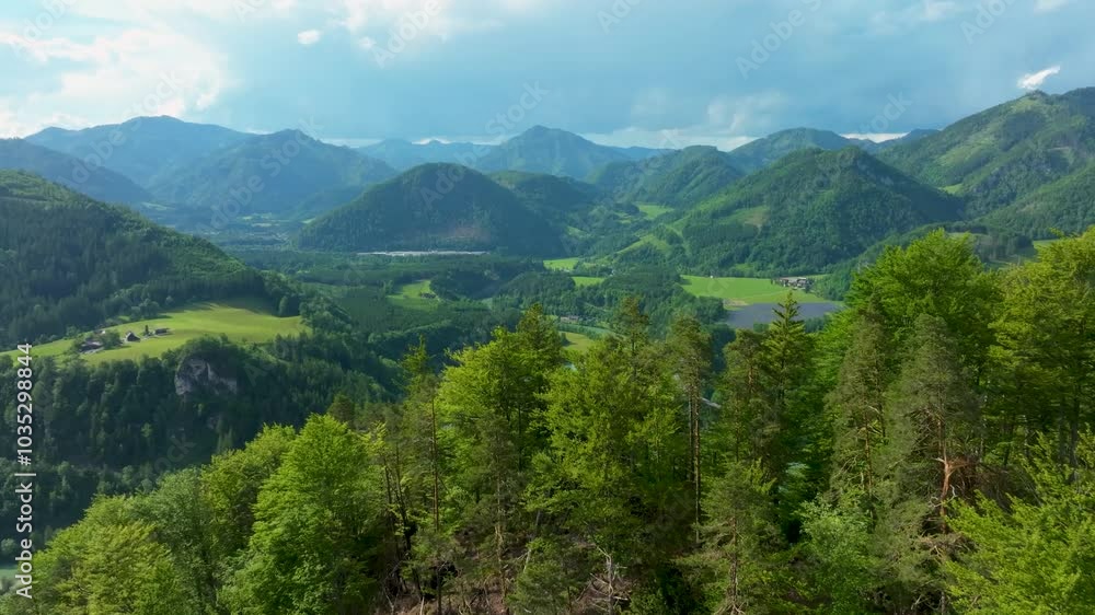 Aerial view of the serene enn river winding through lush, verdant hills and majestic mountains in the styrian alps, Austria. Aerial view of the serene enn river winding through lush, verdant hills and majestic mountains in the styrian alps, Austria.