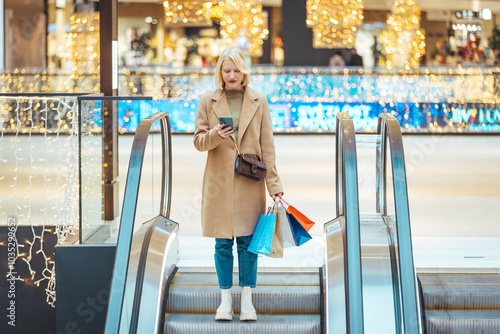 Obraz na plátně Stylish Woman Enjoys Holiday Shopping In Festive Mall Setting