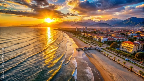 Breathtaking Sunrise Over Lido di Camaiore Beach and Apuan Alps in Tuscany, Italy photo