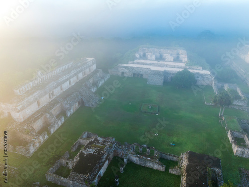 Aerial view of ancient ruins shrouded in mist and surrounded by lush landscape, Santa Elena, Yucatan, Mexico. photo