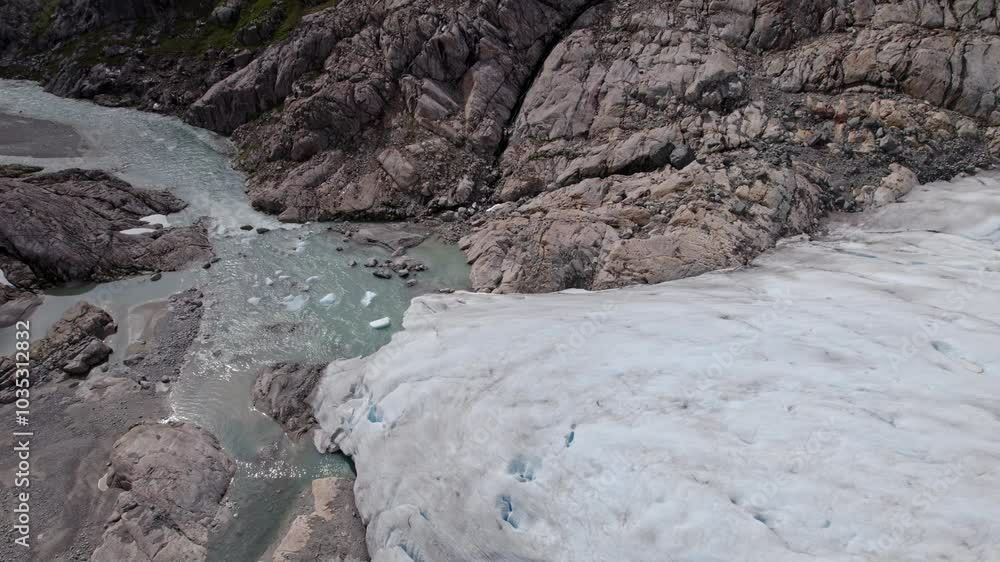 Nigardsbreen Glacier Meltwater Flowing Into River Amidst Rocky Landscape Nigardsbreen Glacier Meltwater Flowing Into River Amidst Rocky Landscape