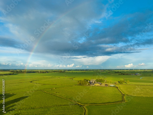 Aerial view of rainbow over peaceful countryside with lush grassland in national landscape Middag-Humsterland, Ezinge, Netherlands. photo