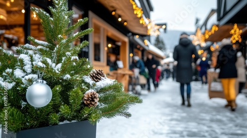 A picturesque snowy street is lined with decorated Christmas trees, as people warmly dressed in coats wander among shops, enjoying the holiday shopping season.