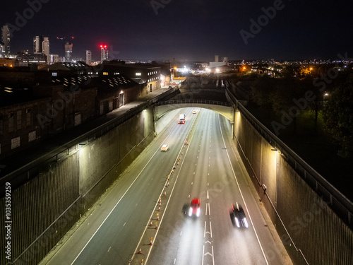 Cars driving on highway surrounded by walls at night in liverpool