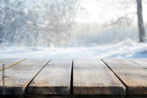 Empty wooden tabletop with blurry snowy forest background for winter and holiday product mockup design photo