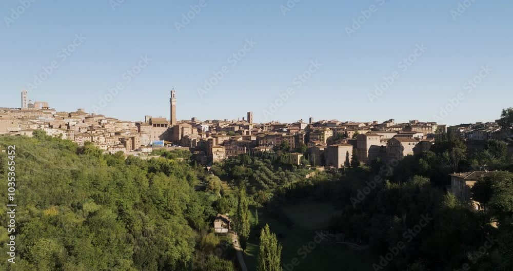 Aerial view of historic medieval architecture and beautiful old town with stone buildings and greenery, Siena, Italy. Aerial view of historic medieval architecture and beautiful old town with stone buildings and greenery, Siena, Italy.