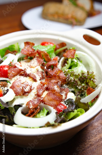 Salad with bacon and cheese and Caesar dressing