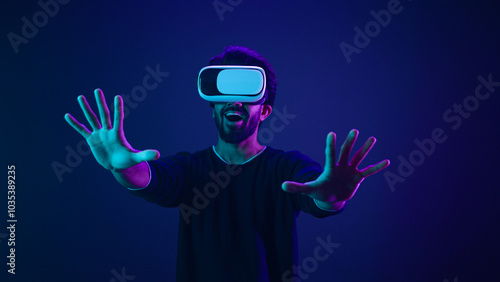 Metaverse virtual reality cyberspace world man play game playing guy meta universe experience digital technology with VR goggles helmet cyber gamer neon ultraviolet futuristic space cyberpunk gaming