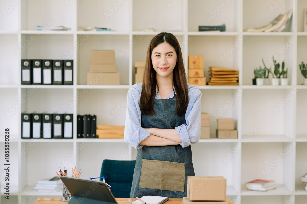 Young businesswoman managing online sales and shipping from a modern home office. Young businesswoman managing online sales and shipping from a modern home office.