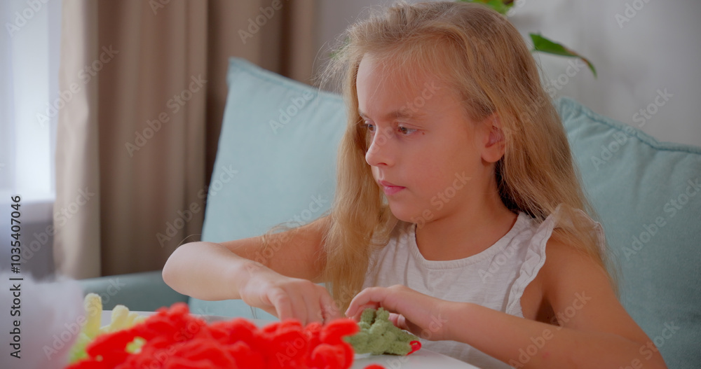 Girl Crocheting a Plush Toy While Watching a Tutorial on a Tablet, Home Girl Crocheting a Plush Toy While Watching a Tutorial on a Tablet, Home