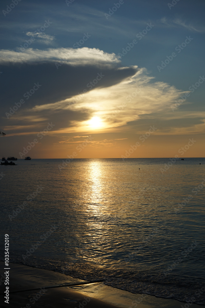 A serene sunset over a calm ocean horizon. A serene sunset over a calm ocean horizon.