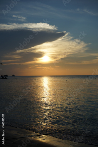 A serene sunset over a calm ocean horizon.