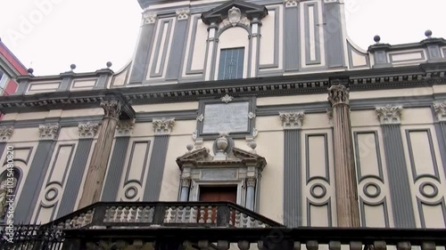 Facade of the Monumental Basilica of San Paolo Maggiore (1600s) in the ancient center of Naples, Italy. There are two Corinthian columns dating back to the ancient temple of the Dioscuri of Naples.