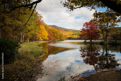 View of serene Sherando Lake surrounded by colorful autumn foliage and tranquil reflections, Virginia, United States. photo