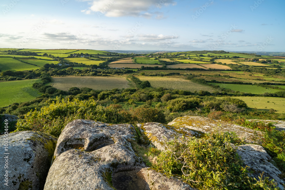 View of rugged Helman Tor with scenic fields and tranquil valley, Bodmin, United Kingdom. View of rugged Helman Tor with scenic fields and tranquil valley, Bodmin, United Kingdom.