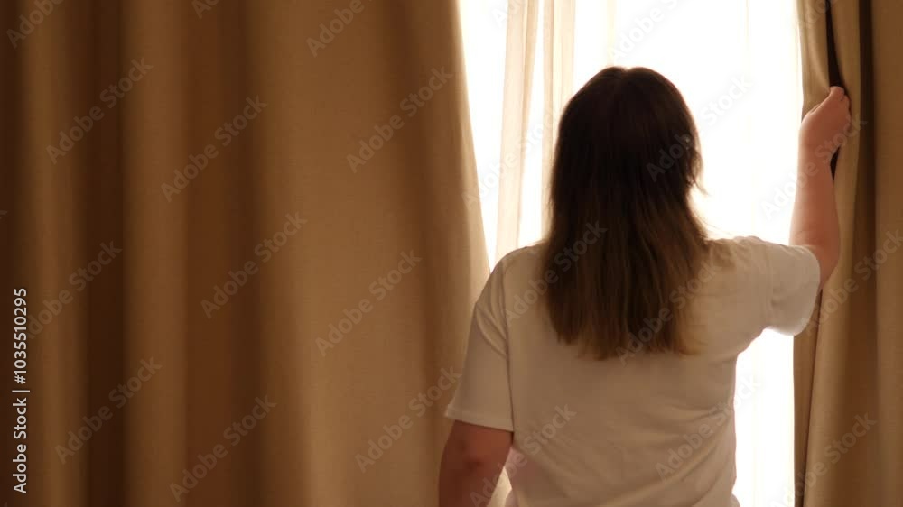 A thoughtful figure illuminated by soft natural light streaming through a window. Closes the curtains. A thoughtful figure illuminated by soft natural light streaming through a window. Closes the curtains.