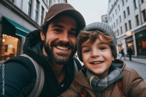 Close up of father and his son taking selfie in city