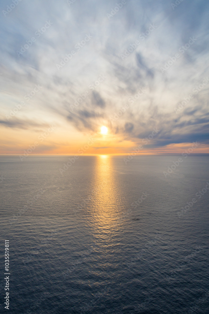 View of the majestic sunset over the Barents Sea with the midnight sun, Honningsvag, Norway. View of the majestic sunset over the Barents Sea with the midnight sun, Honningsvag, Norway.